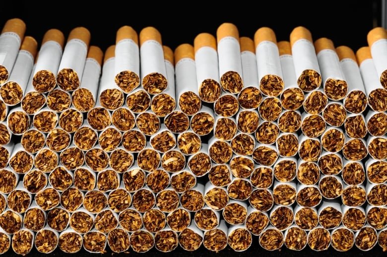 A pile of cigarettes is seen stacked.