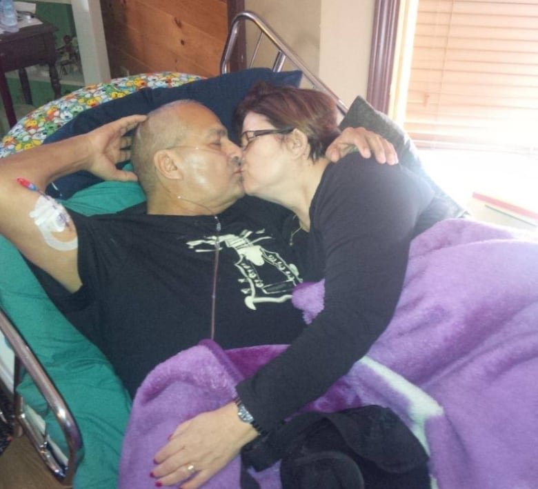 Wife embraces husband during his end of life journey.