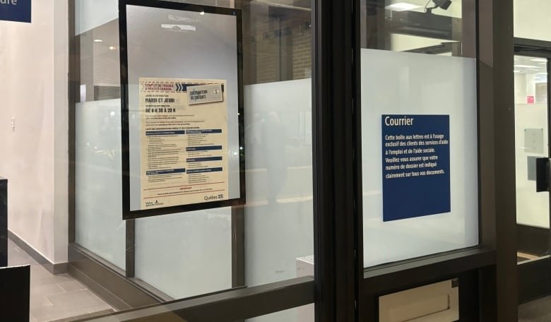 The outside door of a Quebec government office displays a sign that lists all support cheques that are available for pickup.