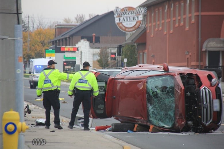 A crashed car on its side.