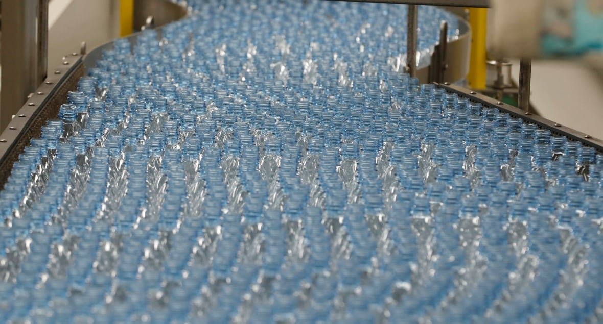 Empty plastic bottles move down a production line to be turned into Dasani bottled water in Salt Lake City, Utah.