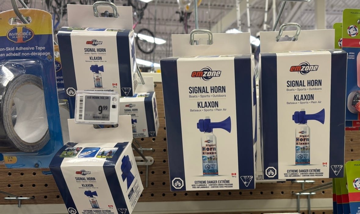 A variety of air horns on a store shelf with the possible uses listed as 'boats, sports, outdoors.'