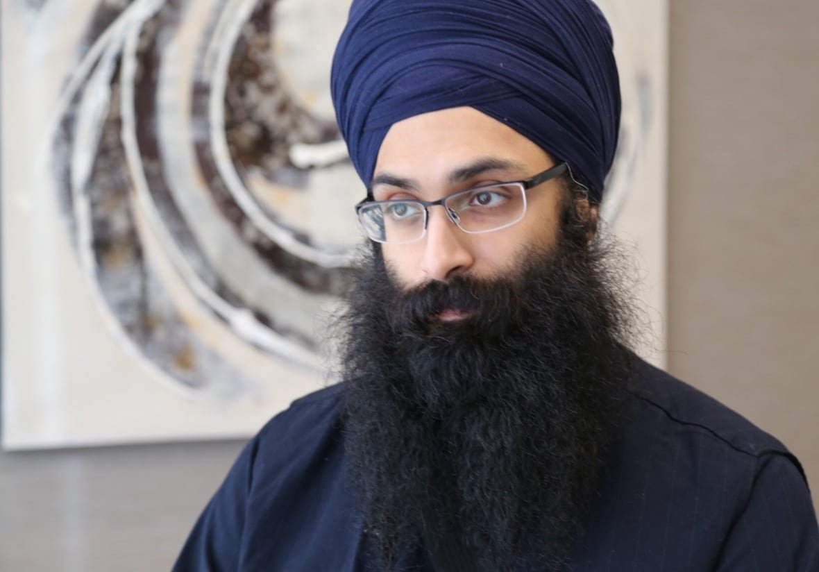 A man with a beard, glasses and turban.