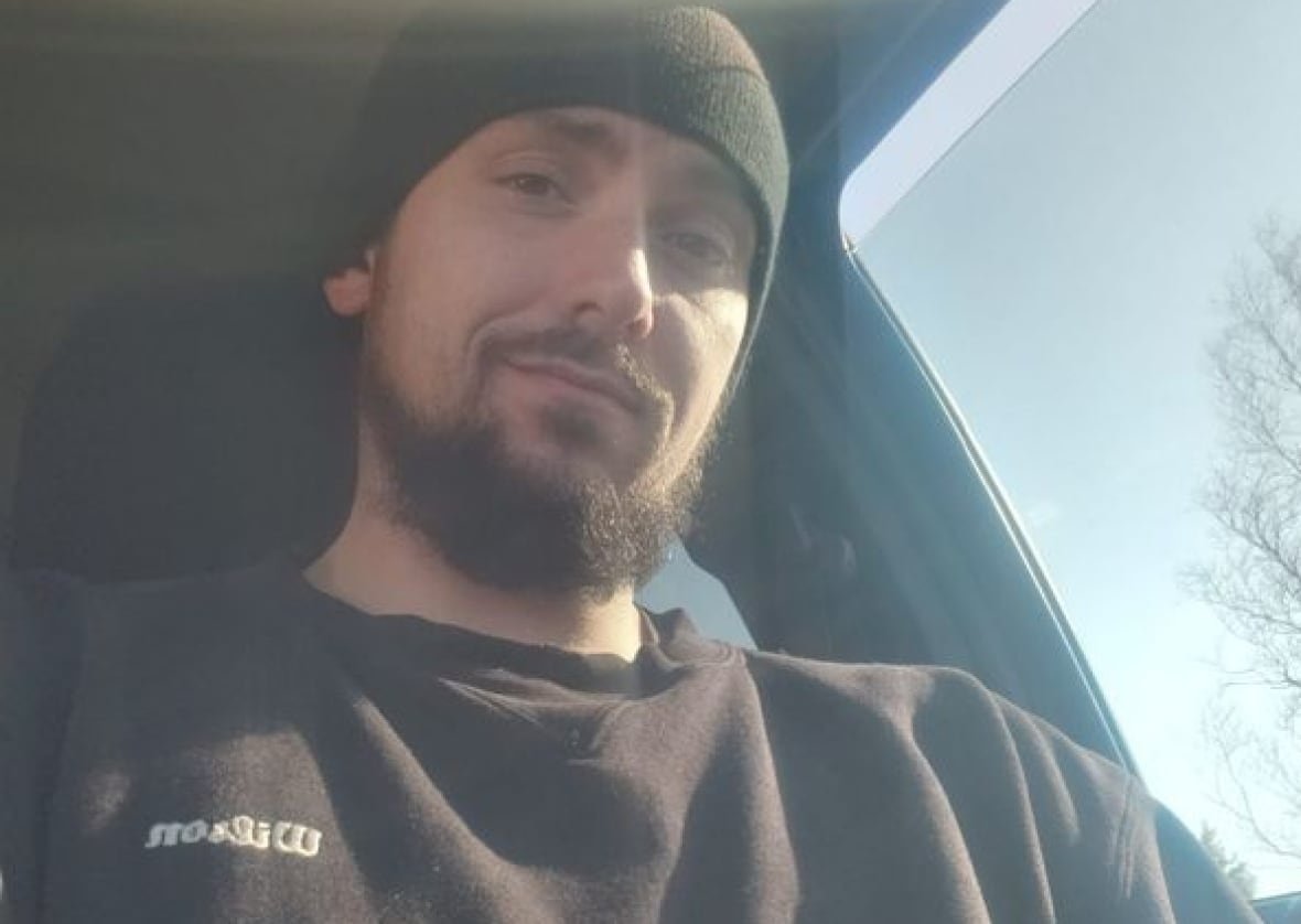 A selfie shows a white man wearing with a beard wearing a beanie an a Wilson sweatshirt.