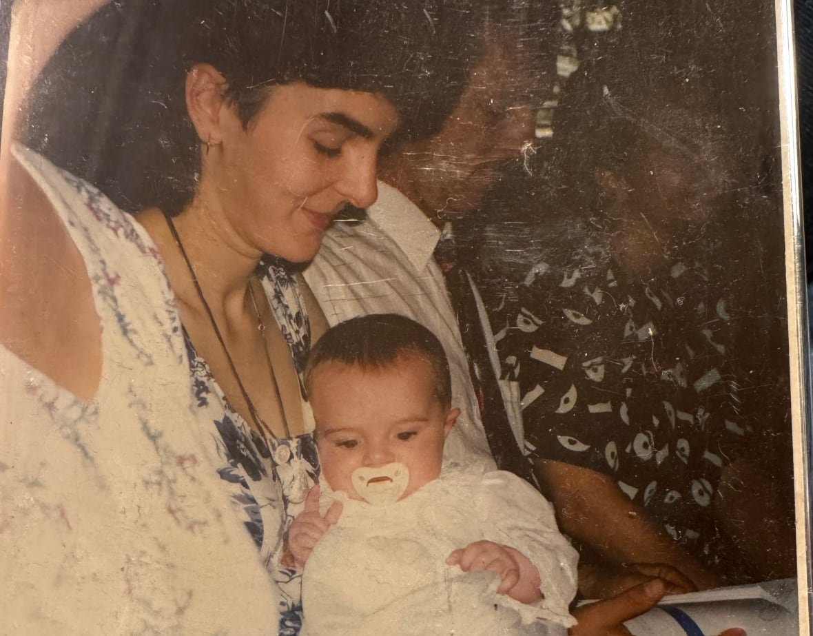 A time-worn photo of a woman cradling a baby.