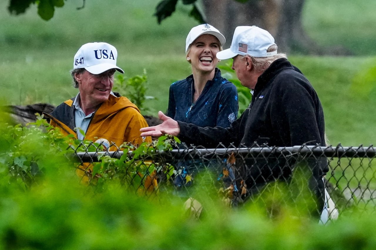 A woman smiles widely at the president.